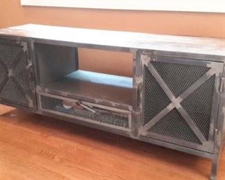 Rustic tv stand/entertainment center. Wood with metal doors.