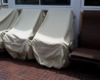 4 rocker/swivel patio chairs with like-new strap-down covers that won't blow away!