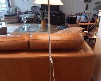One of three floor lamps anchoring the leather sectional.
