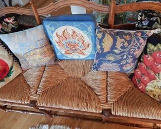 Rush seat bench settee. Several needlepoint pillows.