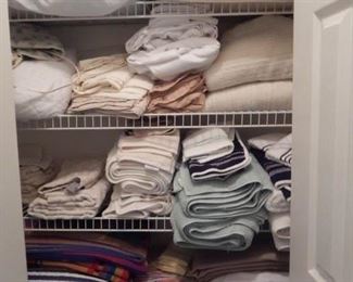 Hall closet full of many linens.