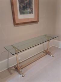 Glass top table with brass finish on base