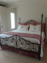 Ornate four-poster bed with custom bed linens