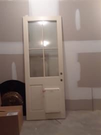 Door with panelled base and four windows on top. Doggie door already installed