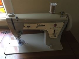 Working Singer machine in cabinet.