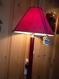 Tall red floor lamp.