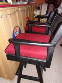 Two vintage swivel black and red bar chairs.