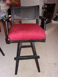 Two vintage swivel black and red bar chairs.
