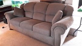 La-Z-Boy sofa with nail head accent. Only one year old and in like-new condition. Greenish-Brown.