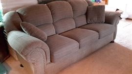 La-Z-Boy sofa with nail head accent. Only one year old and in like-new condition. Greenish-Brown.