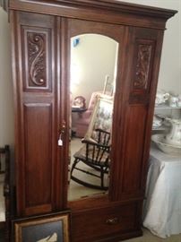 Antique armoire with beveled mirror door