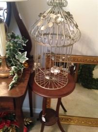 Gold and green bird cage; small round top table