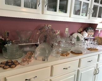 Many glass serving dishes and other glassware, perfect for entertaining.