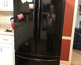 Black Samsung refrigerator, freezer on bottom.