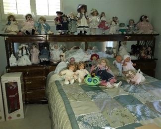Oh, my goodness! Big collection of contemporary porcelain dolls and some vintage dolls--smoke free and pet free home. Shown with vintage bedroom furniture--bed with lighted bookcase headboard. Two end pieces come apart for use elsewhere.