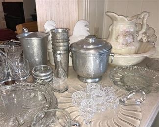 Tables and counters packed full of vintage glassware, hammered aluminum and more.