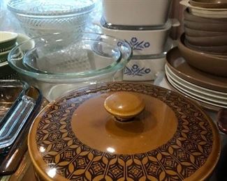 Tables and counters full of Corning Ware, vintage cookware, glassware, kitchenware and more.