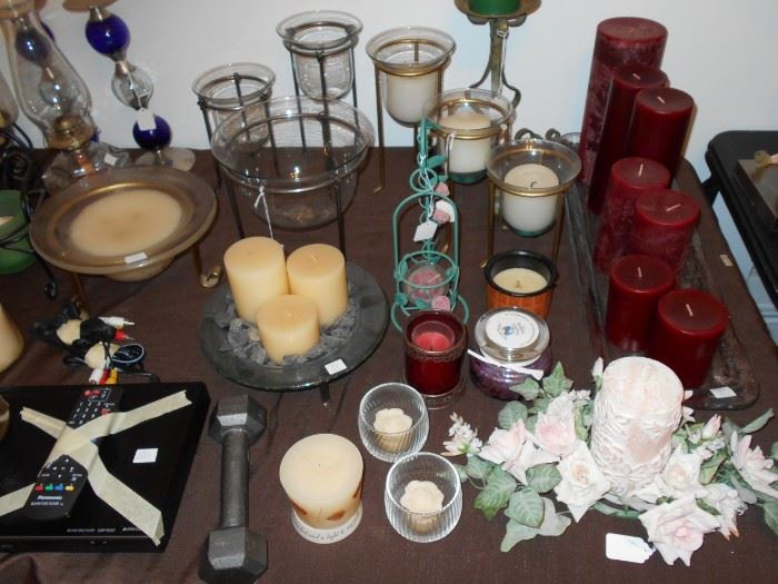 a variety of candles and candleholders