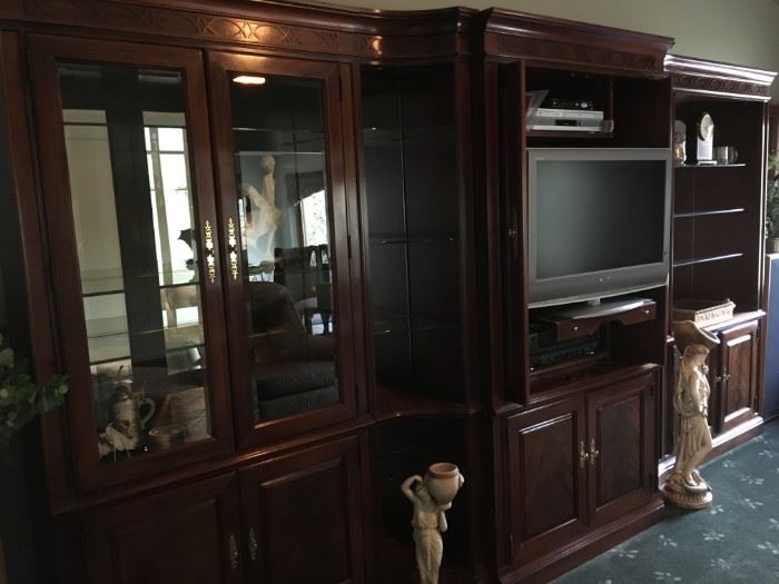 5 piece fine quality wood wall unit by Thomasville.  Featuring  beveled glass-front doors and glass shelving with ample cabinets for storage. Versatile ways to use as one large unit or section off for different usages in other rooms of the home.