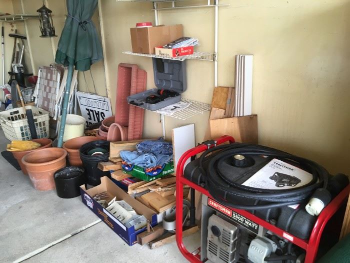 A line-up along the wall of garden and garage goodies. Craftman generator.