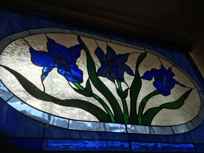 As captured of the blues of spring irises in bloom -stained glass window panel.