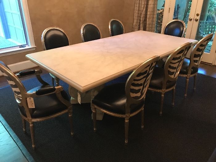 Michael Taylor Designs Stone dining table with Split Lyre base. Set of eight Nancy Corzine Louis XVI style dining chairs.