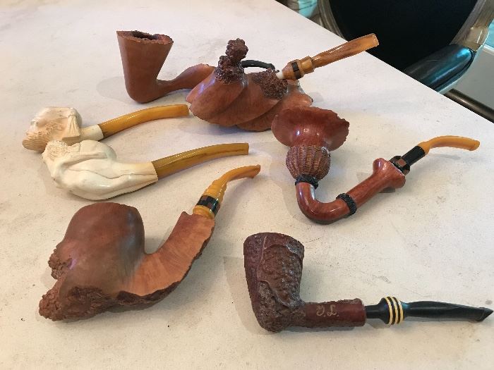 Collection of carved wood and bone pipes.