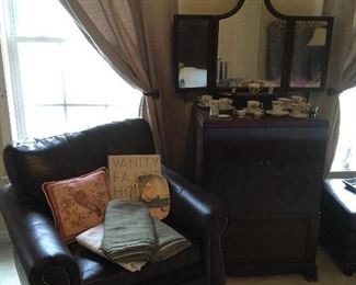 Leather Chair, Antique Dresser Mirror, Antique TV in Cabinet.