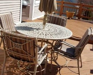 round, metal outdoor table w/ umbrella and 4 chairs