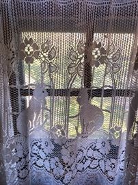 lacy cat curtains with brass cat finials