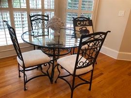 Ornate wrought iron glass-top dinette set dining Ashley Furniture