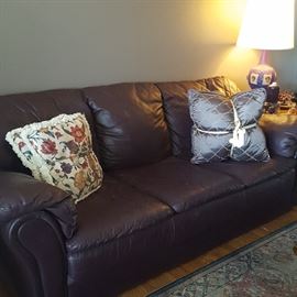 Leather sofa and matching love seat, deep purple