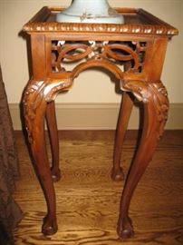 One of a pair of ornately carved stands