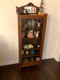 Vintage display cabinet with an assortment of collectibles 