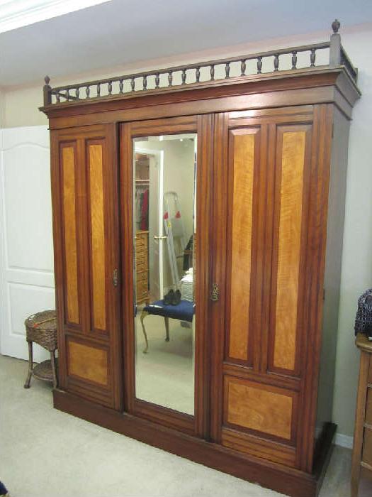 Mahogany Armoire, likely made in England.   Late Eastlake 1890s-Early 1900s. Beautiful. Three doors.  One is a closet, the other two open and have wonderful pull out drawers.