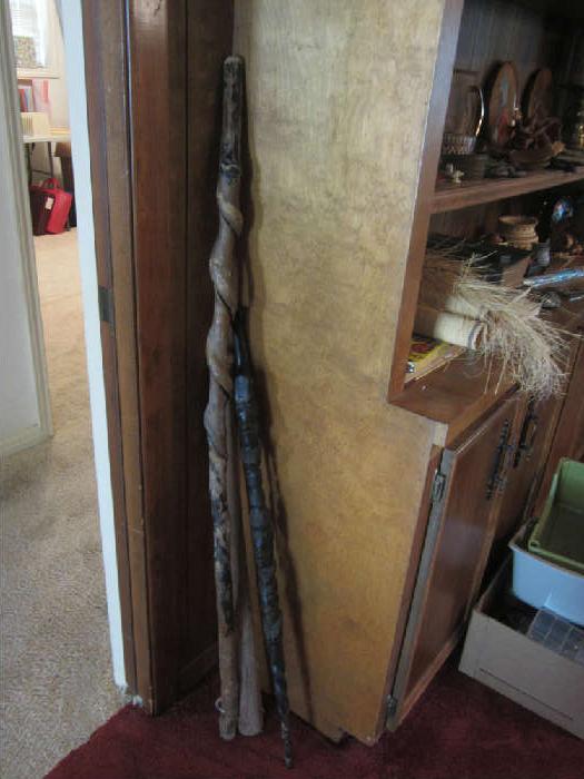 Walking Sticks.  The tall twisted stick is from Nigeria.  A tree would wrap its vine around the limb and cause the stick to appear twisted.  The men would use these as they walked in the marshes.