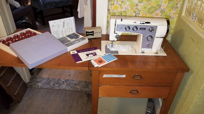 Sear sewing machine with stand, accessories, books & plastic case below.