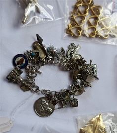 Charm bracelet with many sterling charms.