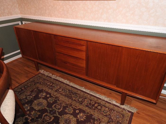 Buffet is just over seven feet at 86 3/4 inches long. It is approximately 31 3/4 inches tall and 18 1/2 inches deep.