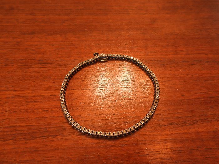 14k Tennis bracelet "'''^^^^^^^ 12 grams total weight. 80 diamonds at 1.5 points equaling over 1.2 carats total in diamonds.