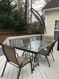 Patio table (custom made from cast iron sewing machine bases); chairs; umbrella