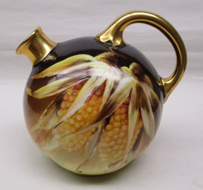 Porcelain corn ball liquor jug. Hand painted with an image of fall color corn. Gold finished handle and spout. Unsigned. Attributed to the Count Thun Factory in Czechoslovakia.
