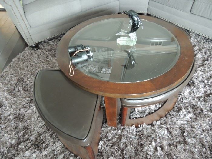 Glass top coffee table with four foot stools