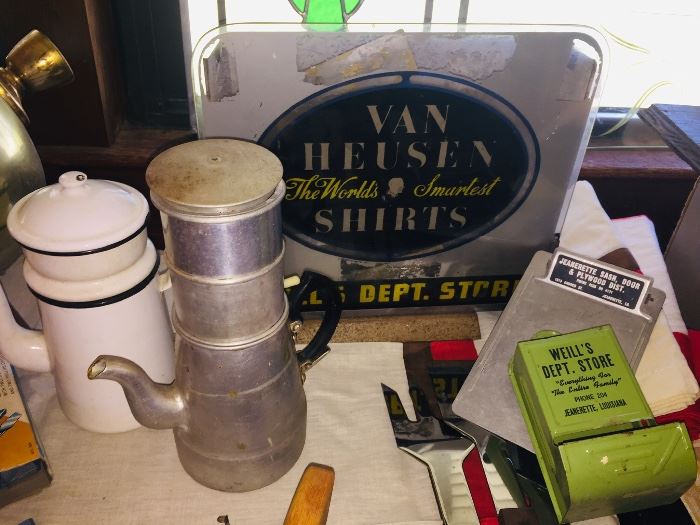 Jeanerette advertising items and old coffee pots--Each table is packed with a crazy assortment of items