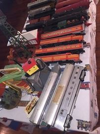 so many trains including the orange Lionel Southern Pacific Engine 8150 and S. Pacific Daylight Cars