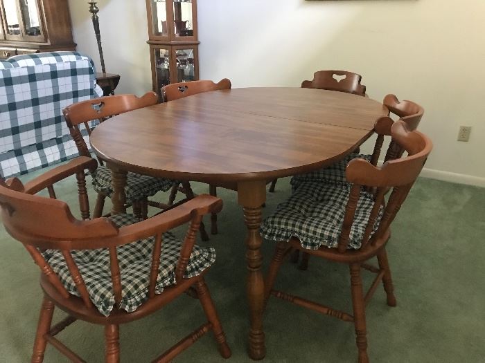 Dining table and 6 chairs.  Table is shown with a large leaf 
