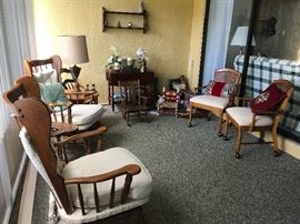 Nicely appointed sun room with rocking chairs and side chairs