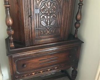 Original finish with carved front opening door and large single drawer!