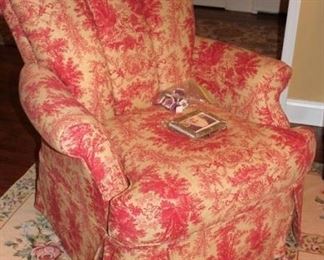 Upholstered Chair and Floral Rug