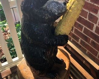 cute carved bear holding a corn cob, I think